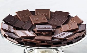 a silver platter filled with a variety of chocolate squares , arranged in a decorative manner at Divan Mersin