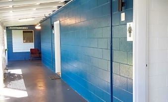 a hallway with blue walls and a white ceiling , featuring two doors on either side at Cooktown Motel