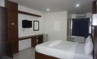 a clean and well - organized hotel room with a large bed , a tv , and a bathroom at S.K. Park Hotel