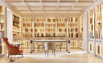 a modern library with wooden bookshelves filled with various books , creating a cozy and inviting atmosphere at El Fuerte Marbella