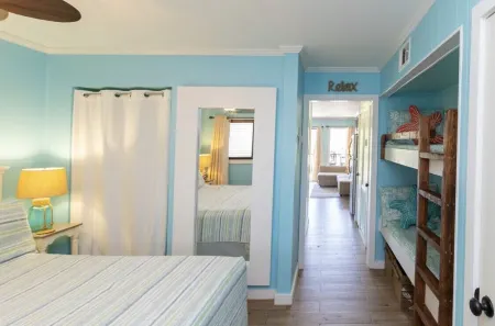 Peek of the ocean King size bed just Steps from the Beach