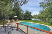 Mid-Century Boho Chic home with Pool, Game Room & Outdoor Playhouse.