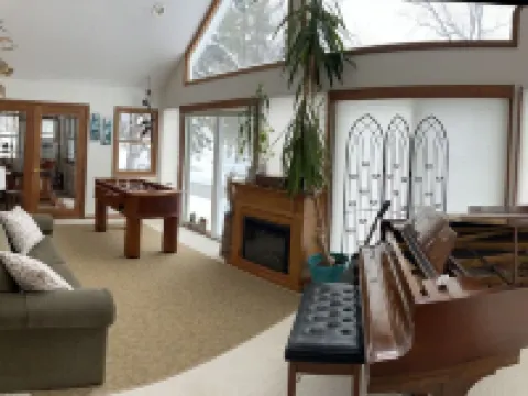 The Gray Escape Steps away from Lake Margrethe Hotels in Grayling Township