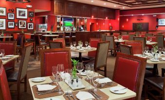 a well - decorated restaurant with various dining tables and chairs , creating an inviting atmosphere for guests at DoubleTree by Hilton Hotel Cincinnati Airport