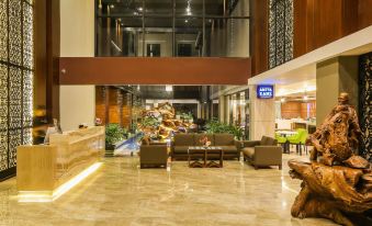 a spacious lobby with high ceilings , marble floors , and large windows , as well as comfortable seating arrangements at Swiss-Belinn Timika