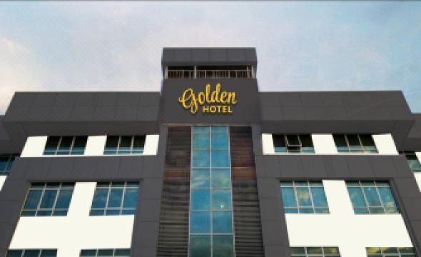The hotel building is adorned with golden, green, gold, and silver tones at Golden Hotel