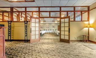 a large , empty room with two long dividers separating the dining area from the rest of the space at The Inn at GIG Harbor