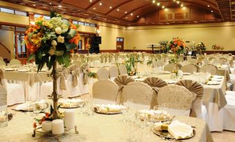 a large banquet hall with multiple tables set up for a formal event , possibly a wedding reception at Hotel Diplomat