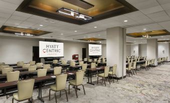 a conference room with multiple rows of chairs arranged in front of a long table at Hyatt Centric Arlington