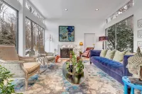 Luxurious midcentury modern glass house in the woods, chefs kitchen & great art