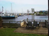 Chalet Gaby with Sauna, Private Dock, and Canoes at Lauwersmeer