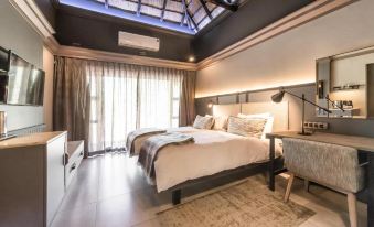 a modern bedroom with two beds , one on the left and one on the right side of the room at Mokuti Etosha