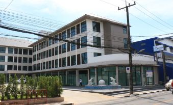 a modern building with a large glass window and a street view of the surrounding area at Klongyai Center