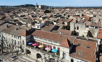 a cityscape with a mix of old and new buildings , some of which are covered in umbrellas at Hotel des Artistes