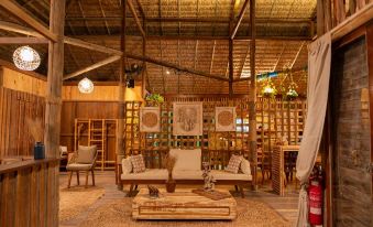 a cozy living room with wooden furniture , including a couch , chairs , and a coffee table at Ventana Hotel