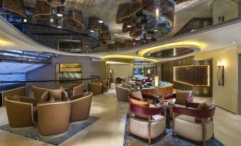 a modern , stylish bar with wooden furniture and unique circular ceiling design , offering a luxurious and comfortable atmosphere at Kempinski Summerland Hotel & Resort Beirut