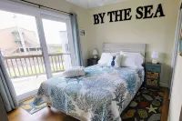 Beachfront 2-bedroom townhome, private beach access, outdoor space & amenities.