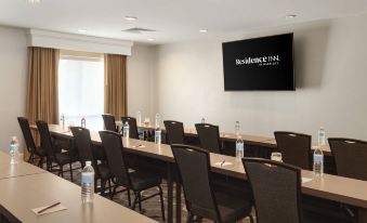 a conference room with a large screen on the wall and rows of chairs arranged in front of it at Residence Inn Philadelphia Willow Grove