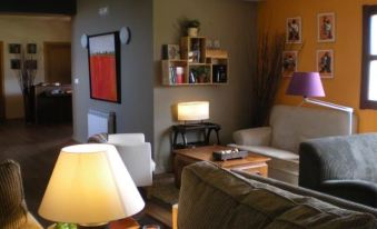 a cozy living room with various furniture , including a couch , chairs , and a coffee table at Punto y Aparte