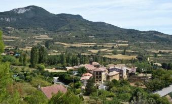 a picturesque village nestled in a mountainous landscape , with a small village nestled at its base at La Casa de Alberto