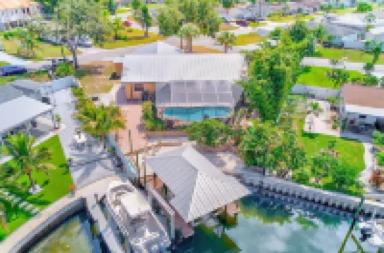 Waterfront oasis with private heated & screened pool, dock w/boat lift. 3BR/2BA