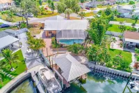 Waterfront oasis with private heated & screened pool, dock w/boat lift. 3BR/2BA