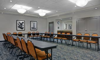 a conference room with several tables and chairs arranged for a meeting or event , surrounded by artwork on the walls at Hampton Inn Bath (Brunswick Area)