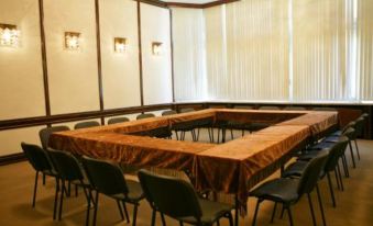 a conference room with a large table surrounded by chairs and a window on the right side at Hotel Bulgaria