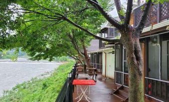 The house in Koregaon Park has a spacious screened porch on its deck at Gapyeong Dasom Pension