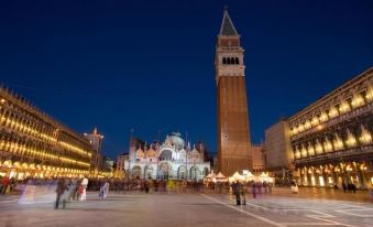 a bustling city square at night , with numerous people walking around and enjoying the festive atmosphere at Hotel President