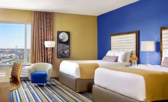 a hotel room with two beds , one on the left side of the room and the other on the right side at The Moonrise Hotel