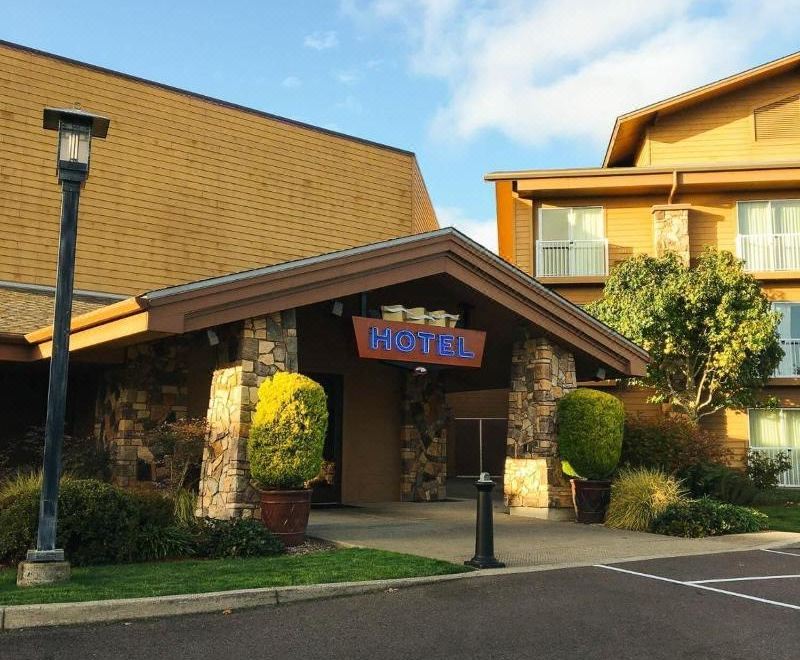 "a brick building with a sign that reads "" hilton hotel "" prominently displayed on the front" at Three Rivers Casino Resort