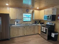 Secluded Cabin with a mountain view, hot tub, full kitchen, and living room.