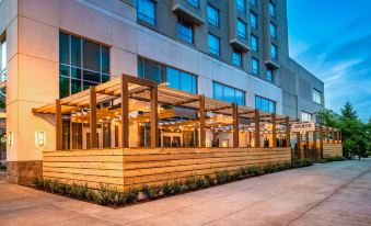 a modern building with a wooden structure and glass walls , providing a sense of openness and comfort at Hilton Vancouver Washington