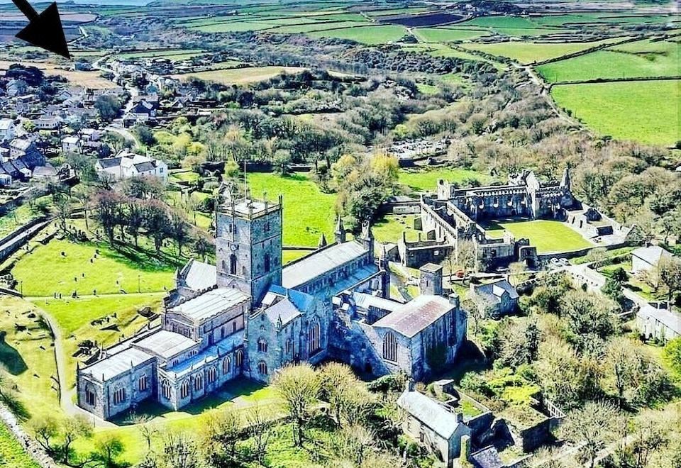 an aerial view of a large , old stone building with a tower and surrounding greenery at Ramsey House - Luxury Licensed B&B - Parking and Guest Lounge