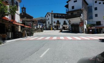 a street scene with a red and white striped crosswalk in the middle of the road at Casa Sierra