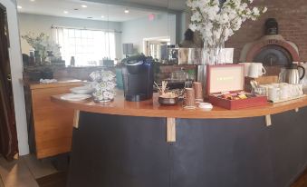 a well - stocked coffee shop counter with various items on display , including cups , coffee beans , and various books at The Inn at Longshore