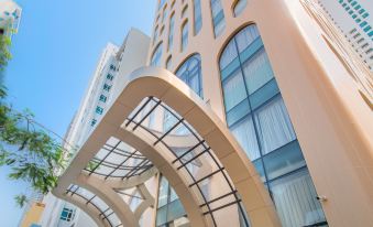 The entrance to a large building with an interesting architectural feature on its front and side at Grand Tourane Nha Trang Hotel