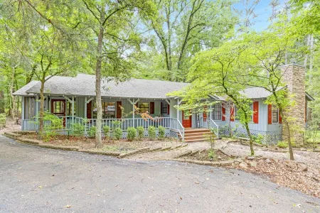 Enjoy 1.3 wooded acres and location to amenities Holly Lake has to offer.