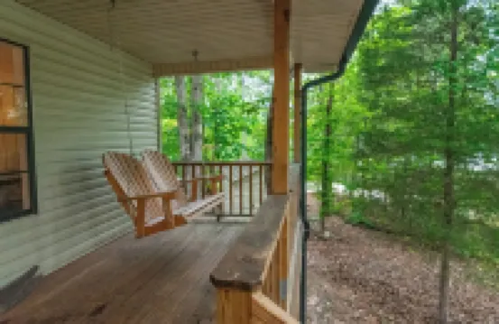 Luxurious cabin with fire pit, kayaks, and dock.