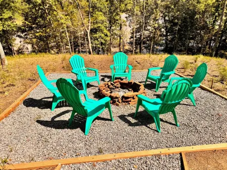 Lake front 4-bedroom house with fire pit and backyard path to the lake.