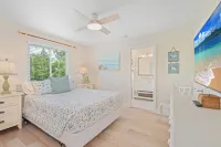 Charming cottage with heated pool, tropical landscaping in prime location.