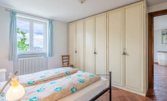 a bedroom with two twin beds , a window , and a closet , under a sloping ceiling at Federica