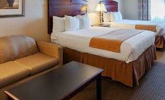 a hotel room with two beds , one on the left side and the other on the right side of the room at Franklin Inn and Suites