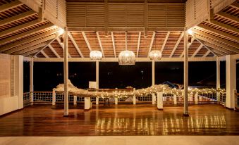 a wooden pavilion with white lights and chandeliers , giving it an elegant and inviting atmosphere at Residences at Nonsuch Bay Antigua