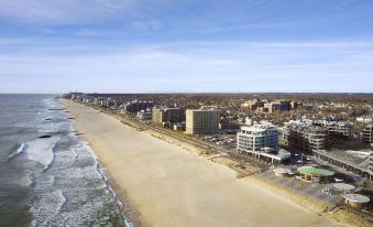 aerial view of a sandy beach near a city , with several buildings in the background at Wave Resort