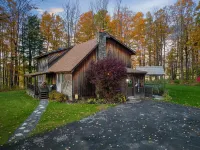 Cabin rental with Hot Tub, Fire Pit, mini fountain pond, hammocks, corn hole.