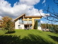 Villa in the mountains in front of a lake.