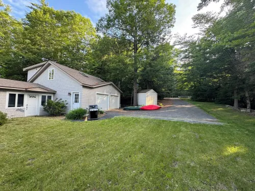 Stunning lakefront home with a boathouse, private dock, firepit and lake views