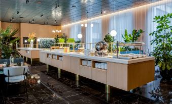 a buffet table with a variety of food items and drinks , including bowls , cups , and bottles at NH Collection Antwerp Centre